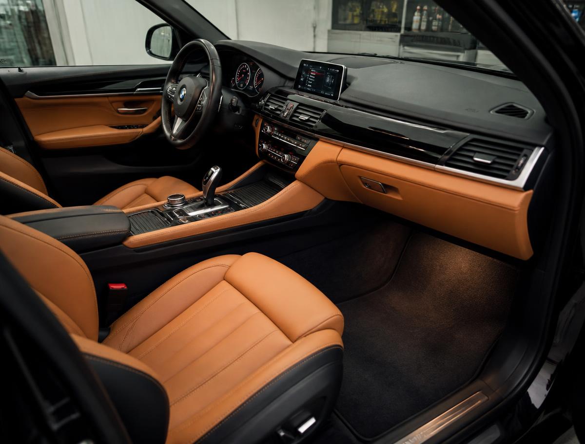 Freshly detailed car interior with clean leather seats and spotless dashboard